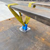 A lifting strap picking up a steel road plate